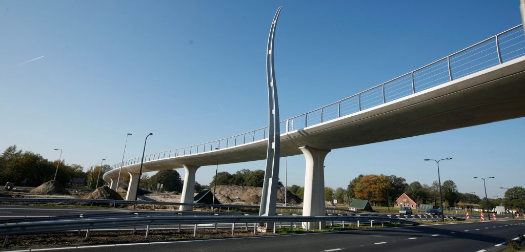 Futuristische voetgangersbrug over snelweg bij daglicht